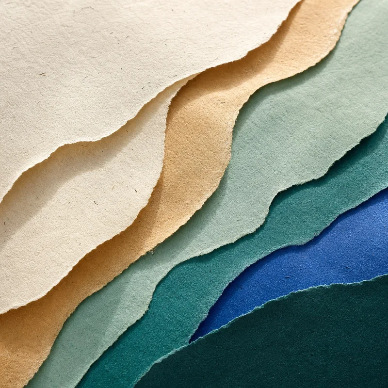 Layered abstract paper in mint, sand, and blue